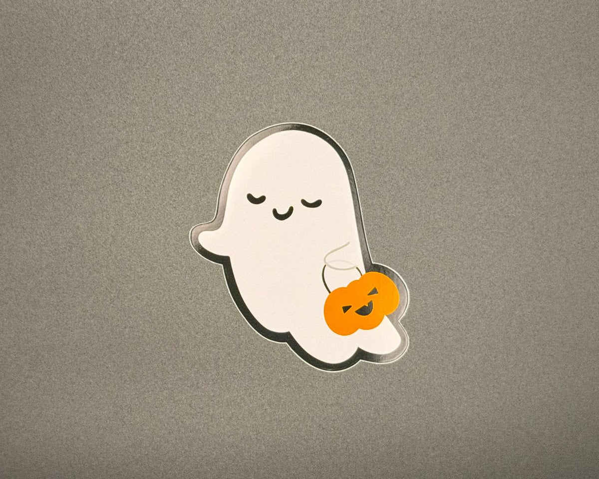 A cute ghost-shaped sticker with a black outline holding an orange jack-o'-lantern.