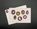 A6 landscape postcard with cute characters (ghost, pumpkin, mushrooms, broomstick, ghost and lantern) in oval shapes on a pink background. 