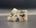Winter Dachsund whimsical washi tape. Dachsunds running, one wearing a blue jumper, one just running and another with reindeer antlers and a red nose. 